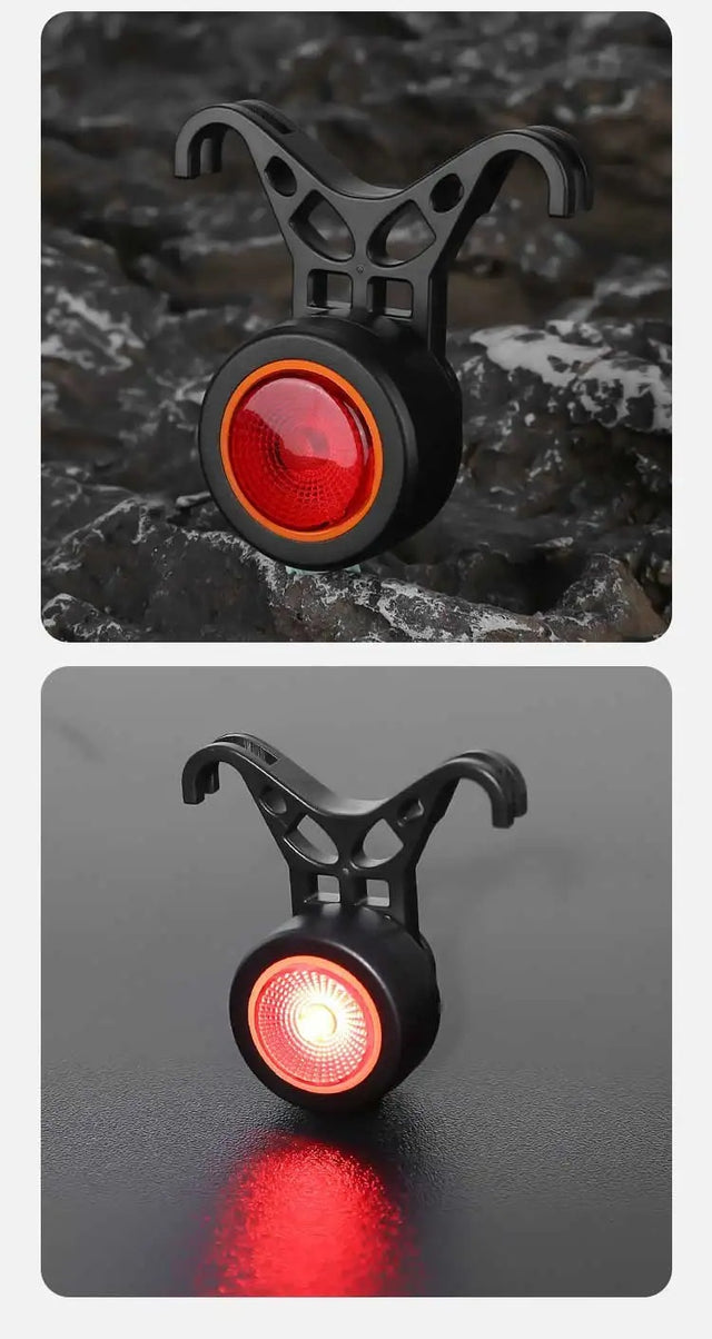 Black round bike light with red lens and hook mount