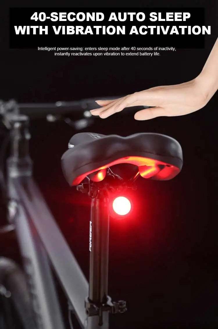 Black round bike light with red lens and hook mount