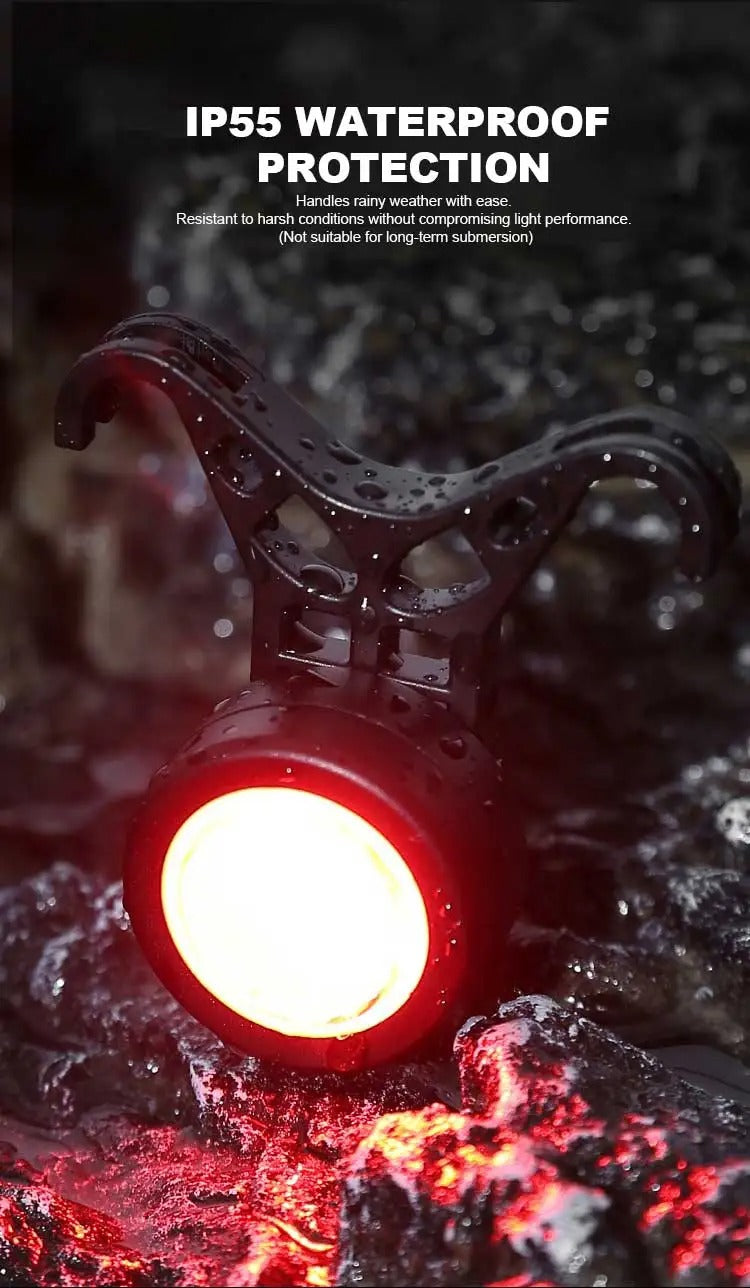 Black round bike light with red lens and hook mount