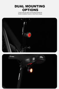 Black round bike light with red lens and hook mount