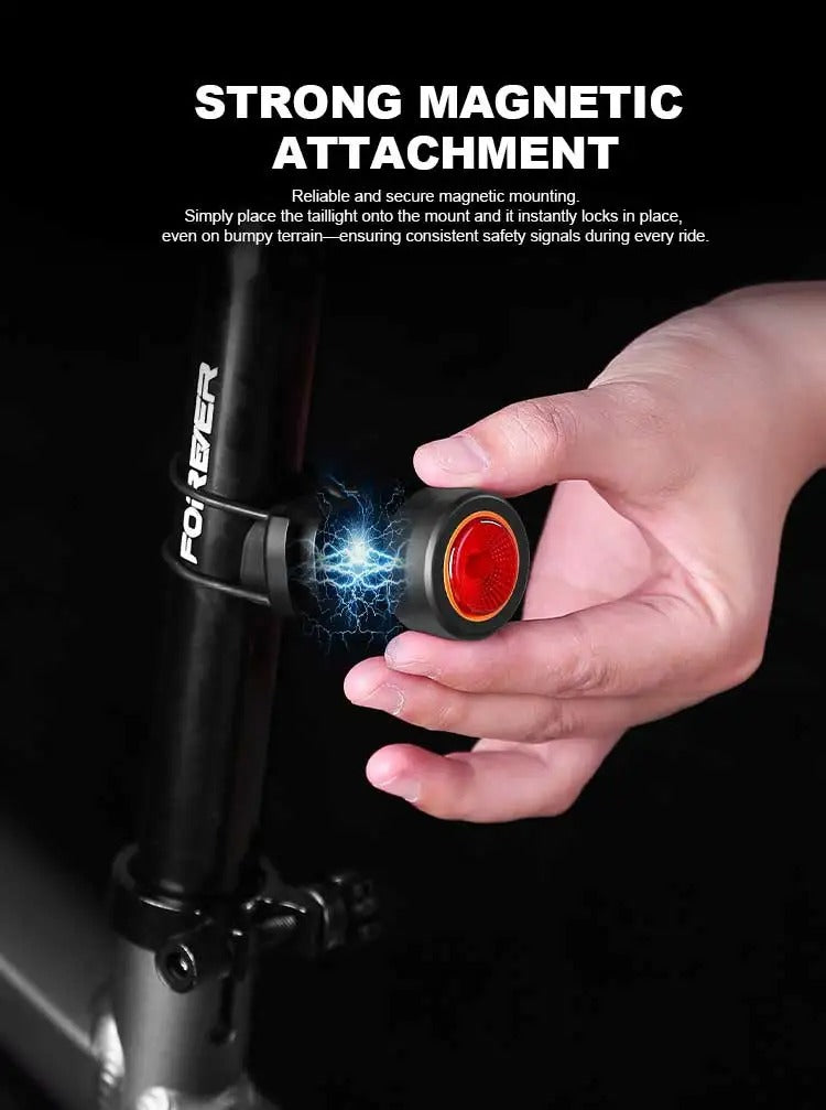 Black round bike light with red lens and hook mount